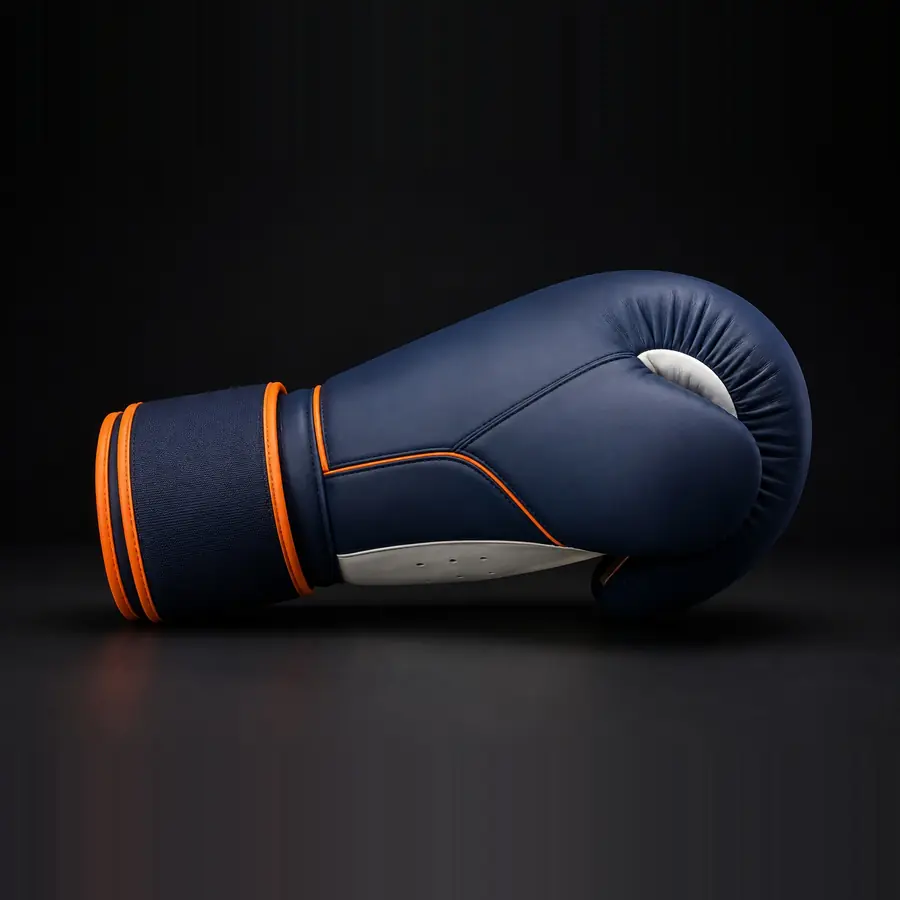 Gant de boxe vu de profil, poing fermé, coloris marine et orange